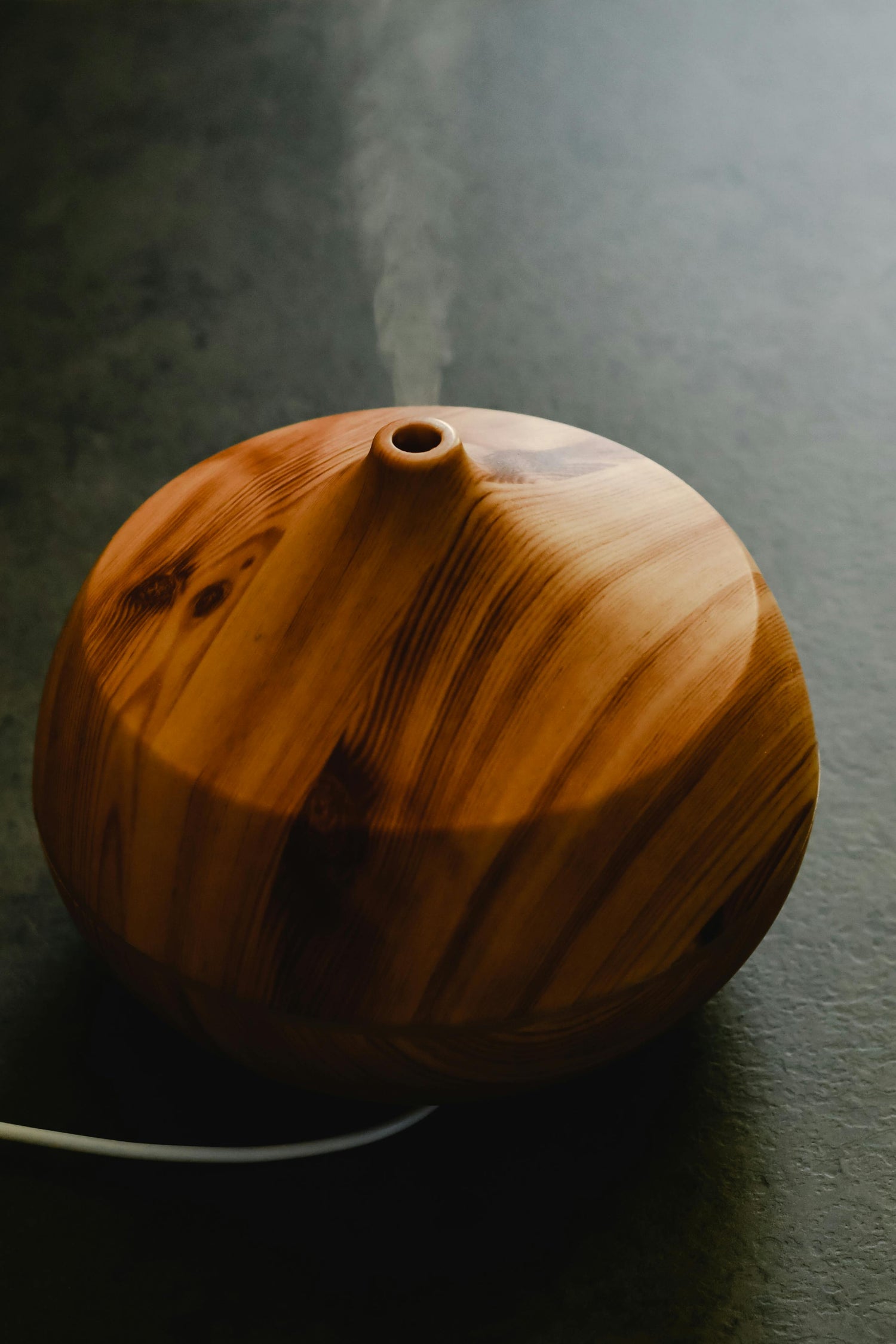 Wooden diffuser on a dark surface